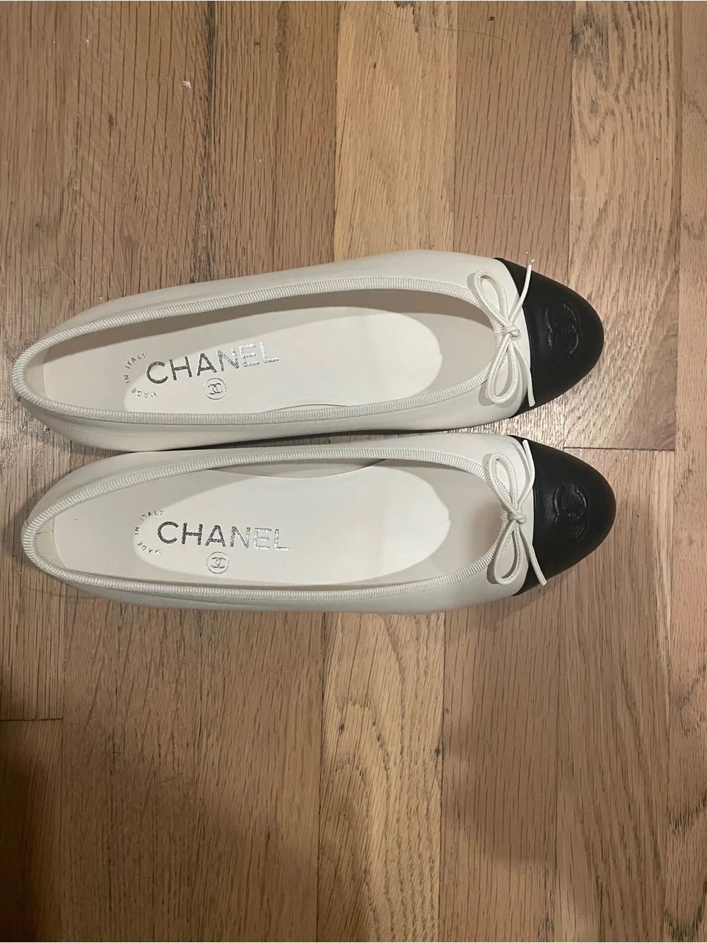 CHANEL Two-Tone Leather Cap-Toe Ballet Flats in Cream and Black